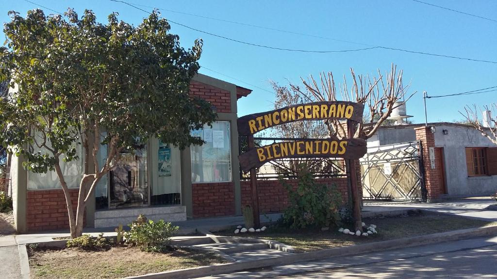 a sign in front of a brick building at Hotel Rincon Serrano in San Agustín de Valle Fértil