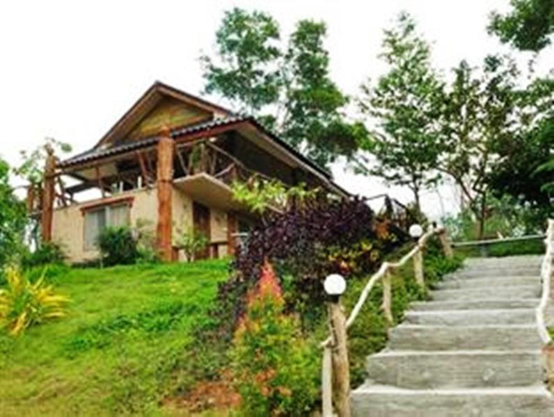 a house with stairs in front of a house at Klongsai Hills in Wang Nam Khieo