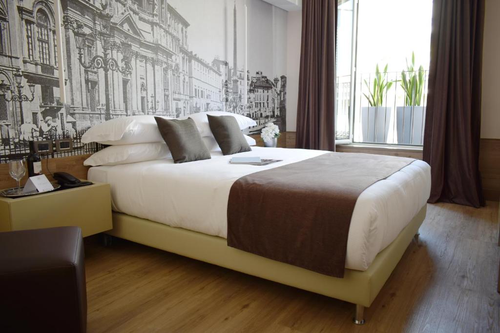 Postel nebo postele na pokoji v ubytování Raeli Hotel Archimede