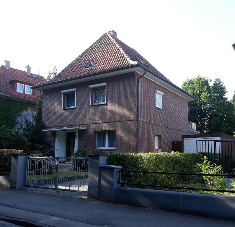 uma casa de tijolos com uma cerca em frente em Tal-Residenz Haus Nr 5 em Bad Salzuflen