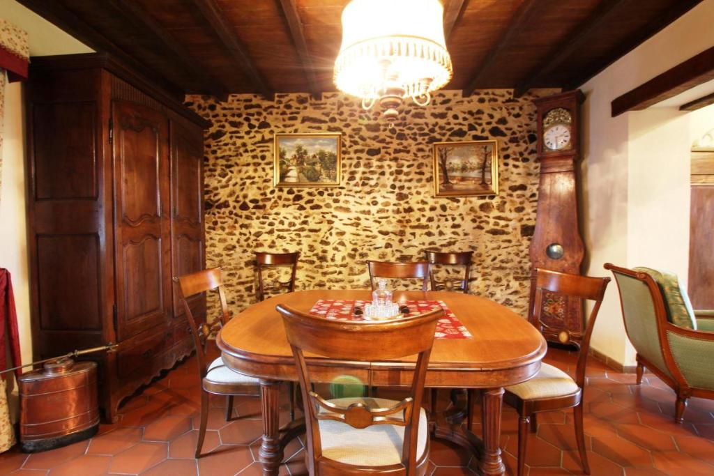 a dining room with a wooden table and chairs at Gîte Yanou in Sault-de-Navailles