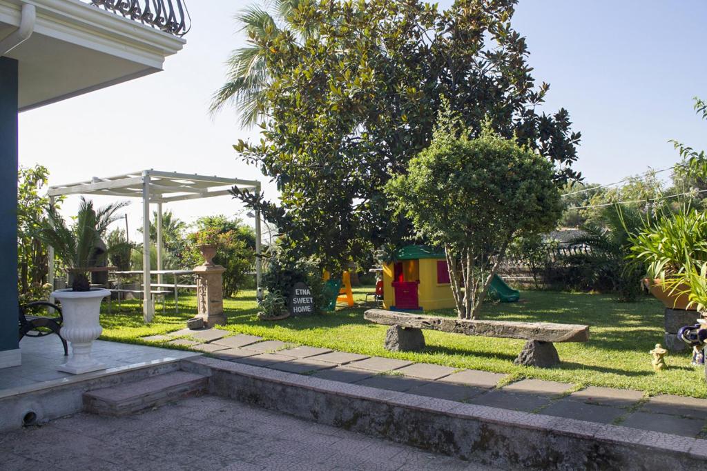 a park with a bench and a playground at Etna Sweet Home in Santa Venerina
