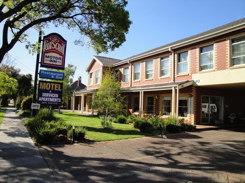 a motel sign in front of a brick building at Footscray Motor Inn and Serviced Apartments in Melbourne