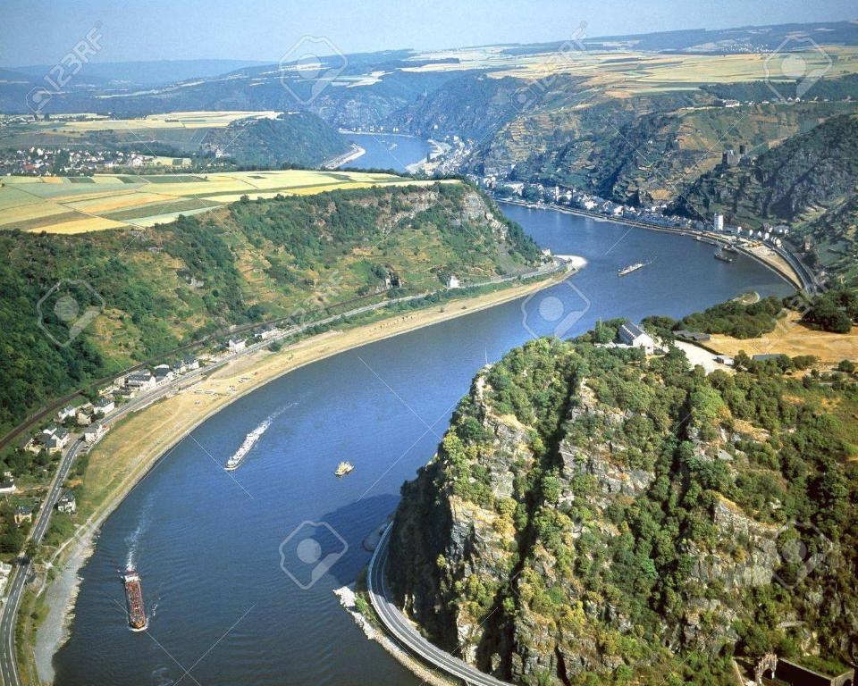 an aerial view of a river with boats at ** Ferienwohnung im Weltkulturerbe nahe Loreley in Niederburg