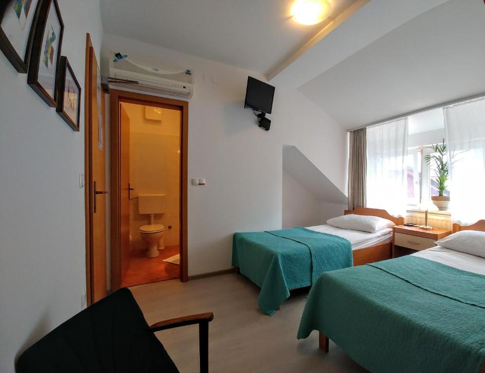 Postel nebo postele na pokoji v ubytování Hotel garni Paleta