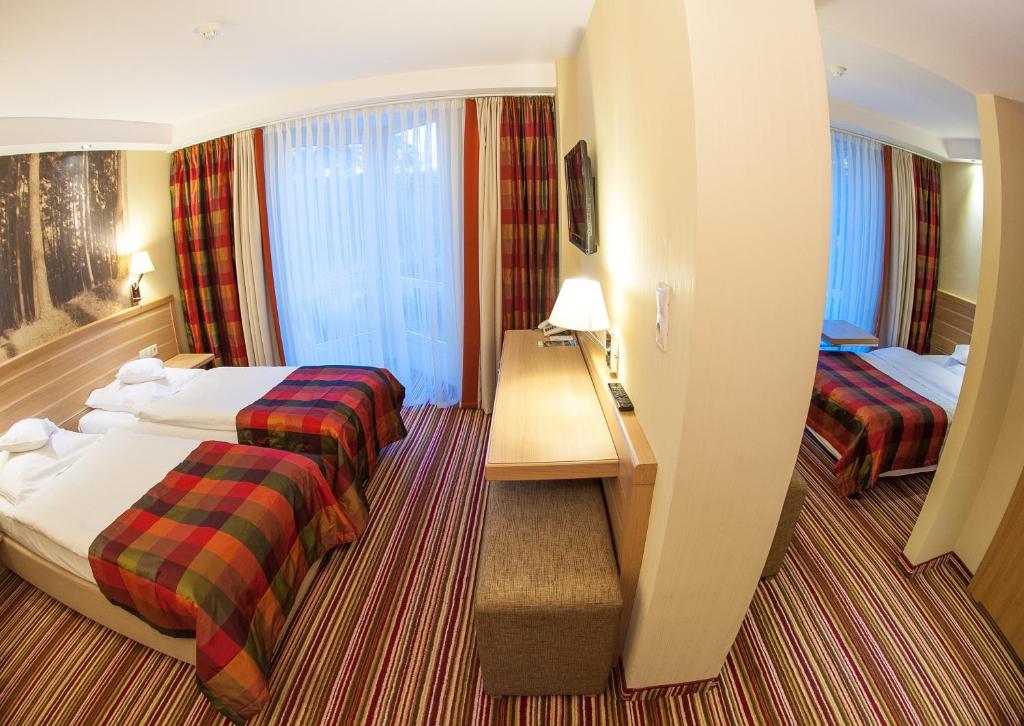 Postel nebo postele na pokoji v ubytování Hotel Warszawa Spa & Resort