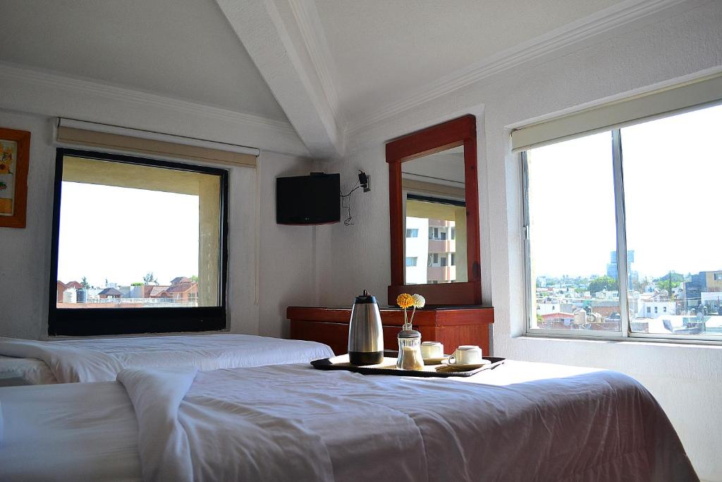 Postel nebo postele na pokoji v ubytování Hotel Campestre Inn