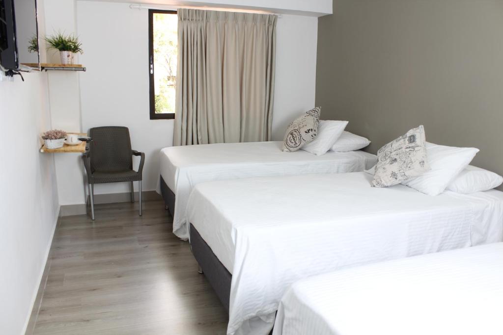 Postel nebo postele na pokoji v ubytování Hotel Boutique Plaza