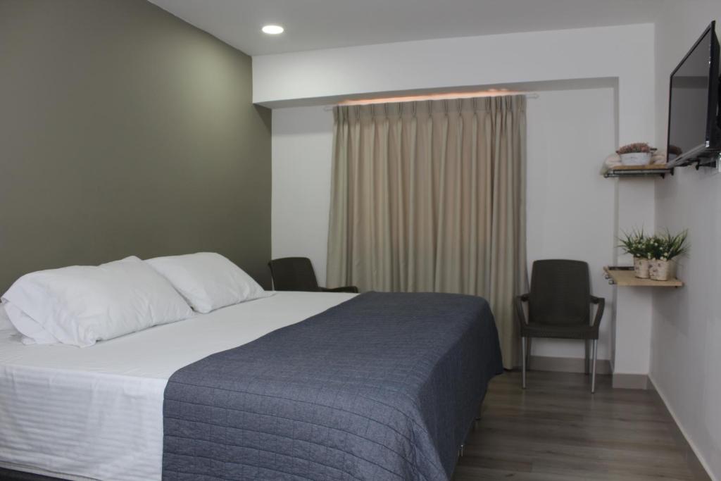 Postel nebo postele na pokoji v ubytování Hotel Boutique Plaza