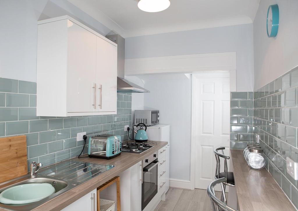 a kitchen with a sink and a counter top at Golden Square Place in Warrington