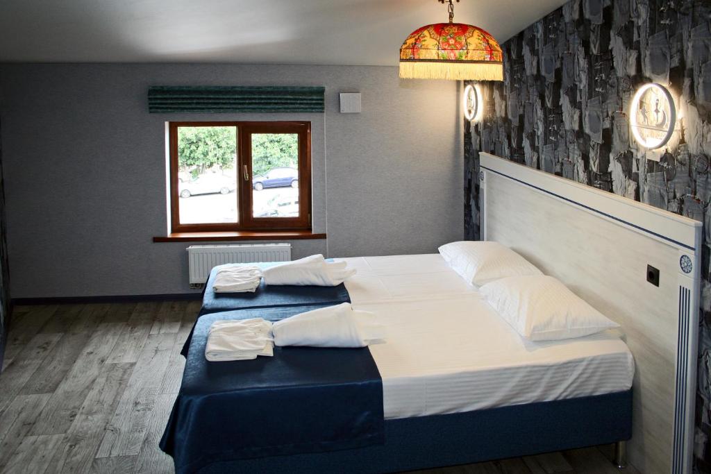 a bedroom with two beds and a window at Hostel Teremok Zhili-byli in Adler