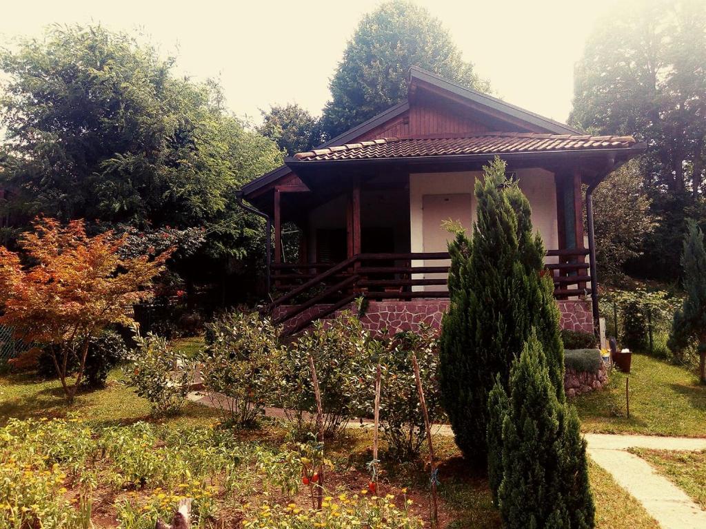 a small house in the middle of a garden at Sunny Paradise in Bihać