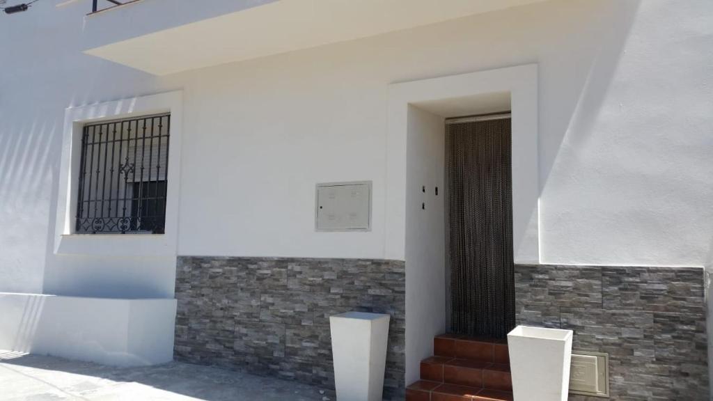 a hallway of a building with a door and stairs at Casa Alma in Almería