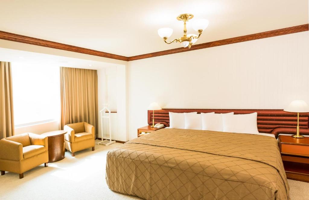 Postel nebo postele na pokoji v ubytování Hotel Tainan