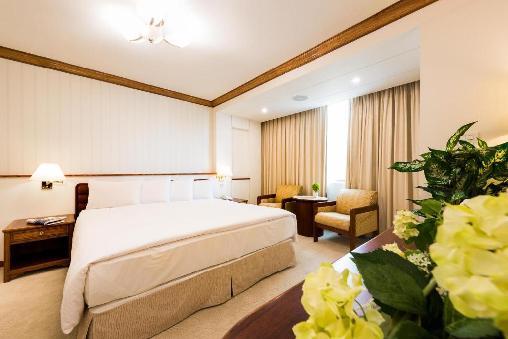 Postel nebo postele na pokoji v ubytování Hotel Tainan