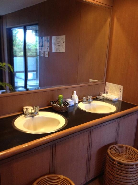 a bathroom with two sinks and a large mirror at Lalaca in Hakone