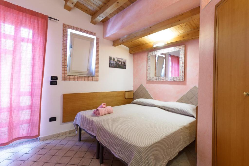 Postel nebo postele na pokoji v ubytování Agriturismo Il Gelsomino Ritrovato