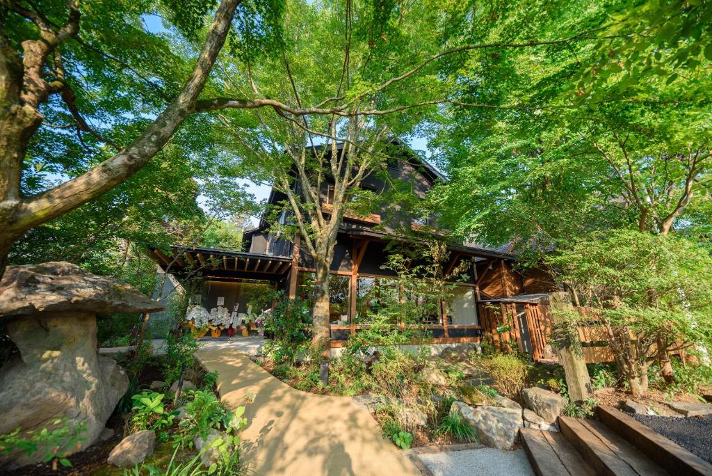 a house in the middle of a forest at Yufuin Iyotomi in Yufuin