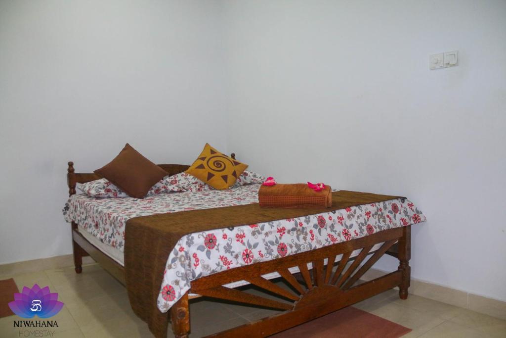 Postel nebo postele na pokoji v ubytování Nivahana Homestay