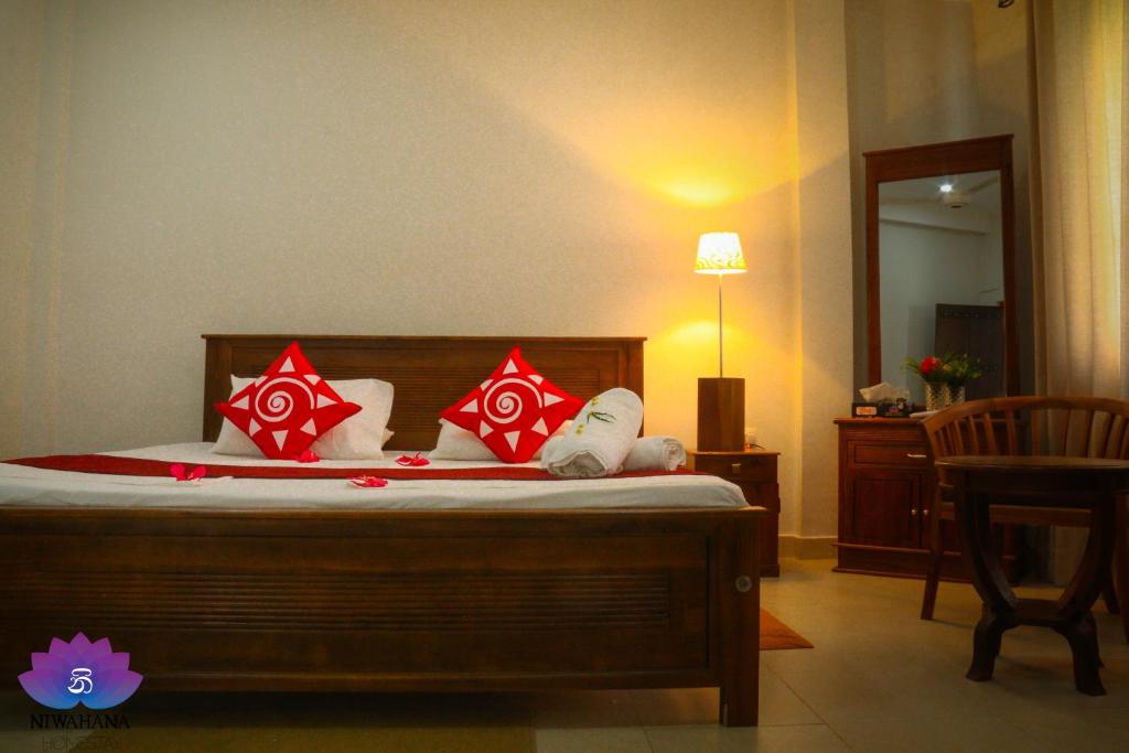 Postel nebo postele na pokoji v ubytování Nivahana Homestay