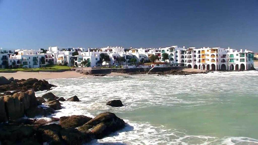 a view of a beach with white buildings at Private Kaliva at Club Mykonos in Langebaan