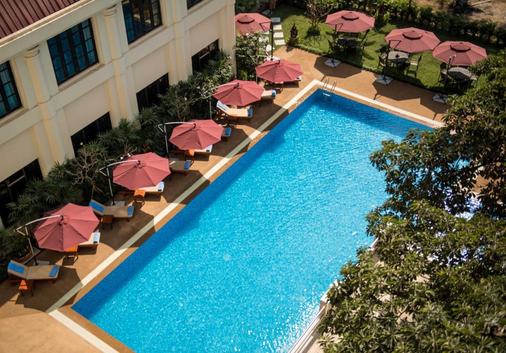 an overhead view of a swimming pool with umbrellas at Rose Garden Hotel in Yangon