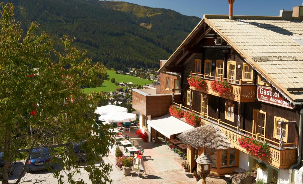 a building with tables and umbrellas in a town at Ferienanlage Reithof in Filzmoos