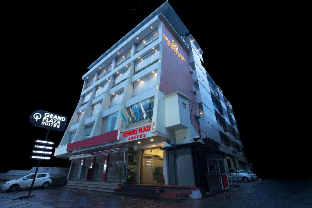 a hotel building with a sign on the side of it at Grand Plaza Suites in Kozhikode