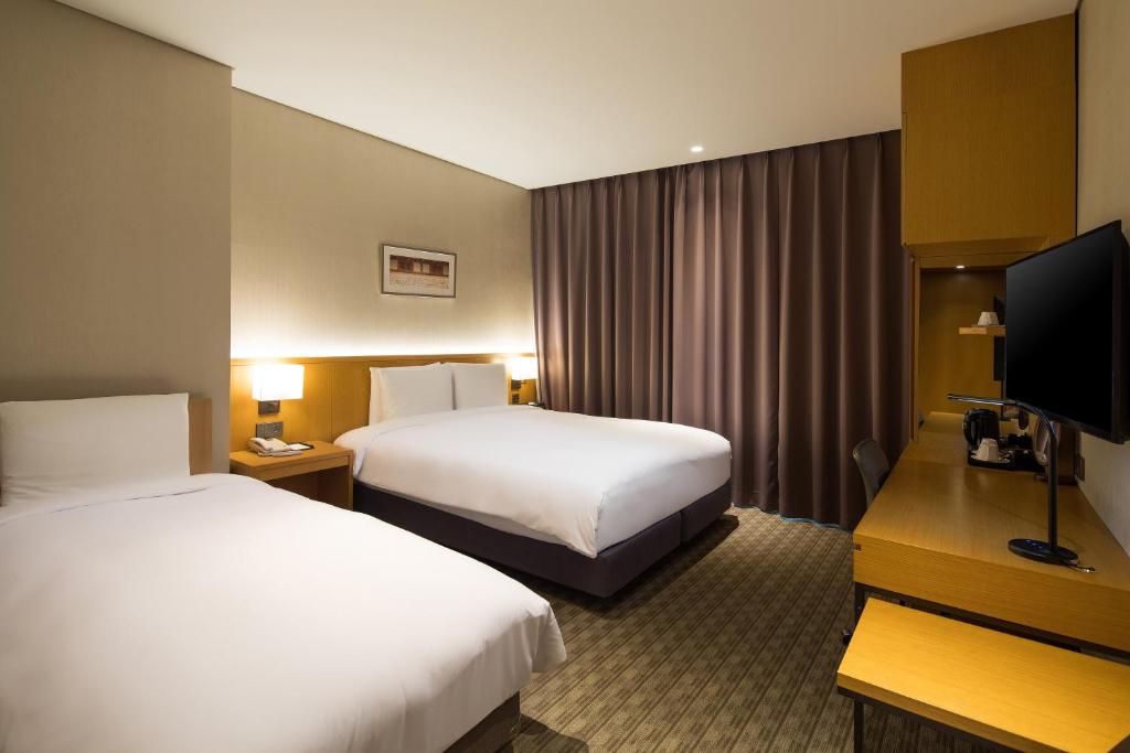 Postel nebo postele na pokoji v ubytování Sotetsu Hotels The Splaisir Seoul Dongdaemun