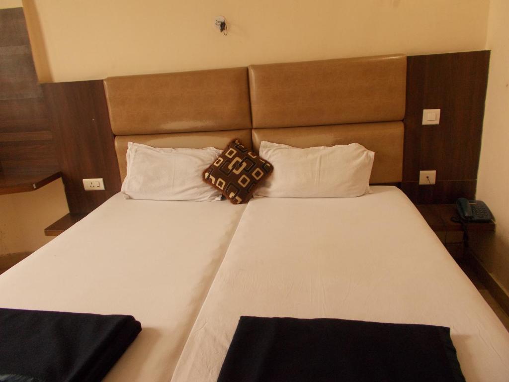 a bed with two pillows on top of it at Budget Stay in the City Center in Rishīkesh