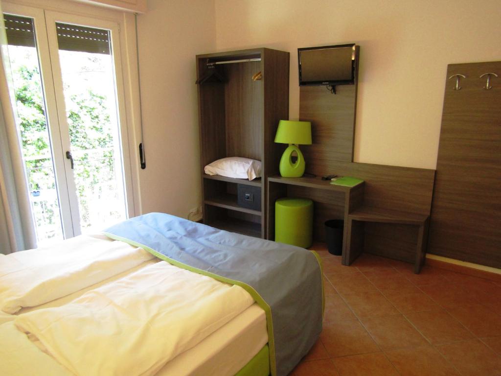 Postel nebo postele na pokoji v ubytování Hotel Menapace