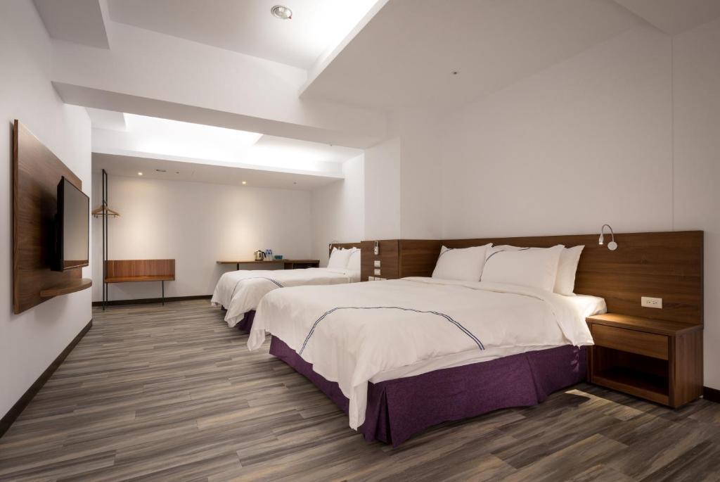 Tempat tidur dalam kamar di Xianghe Hotel