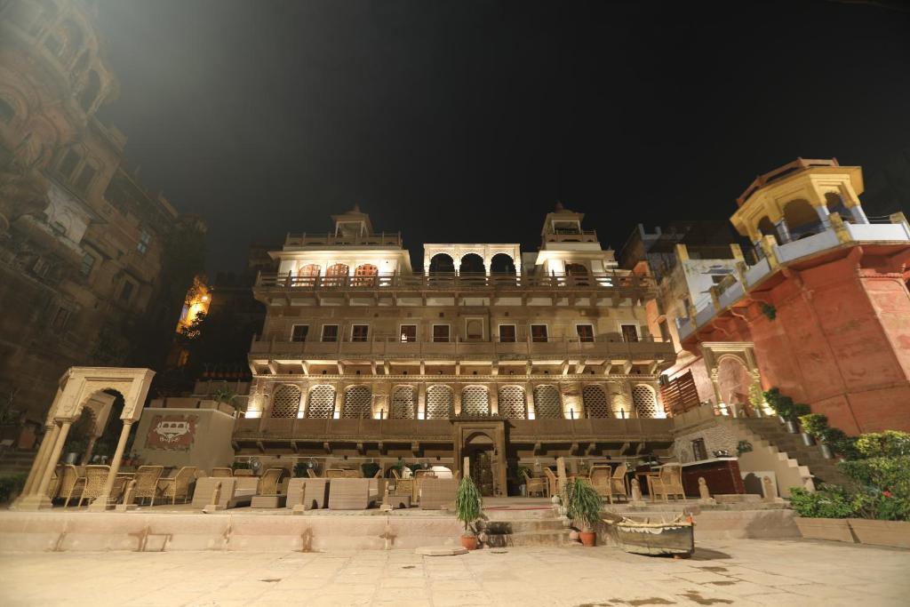 a large building is lit up at night at Guleria Kothi at Ganges in Varanasi