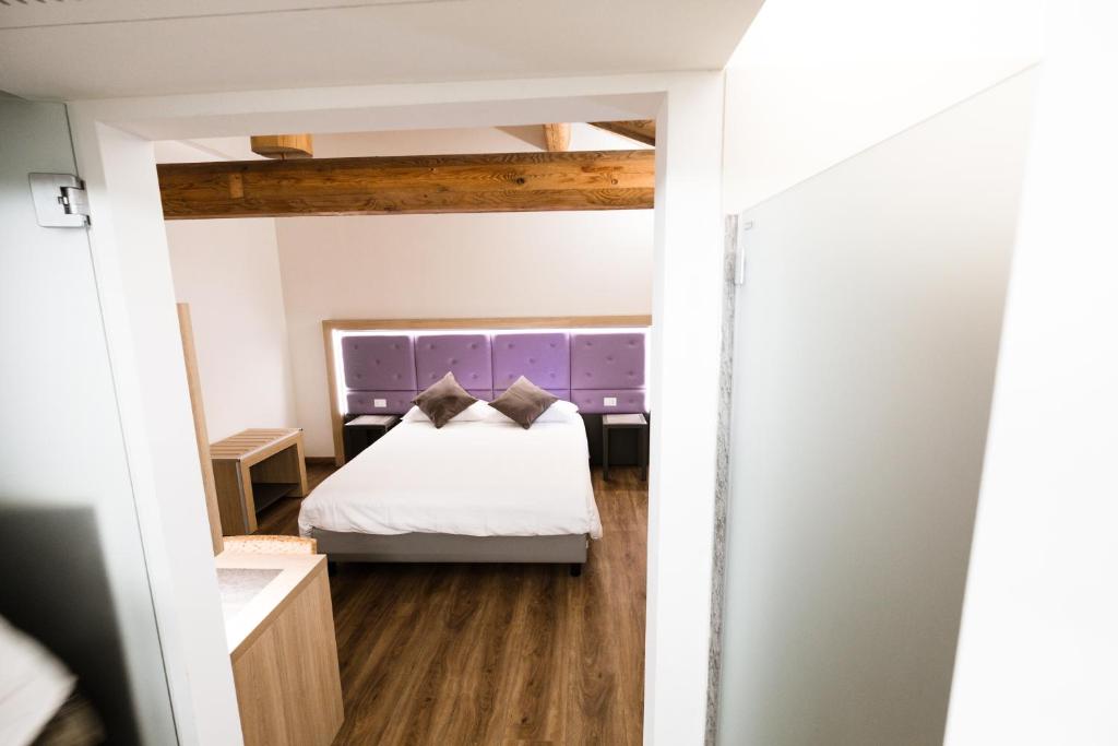 Postel nebo postele na pokoji v ubytování Hotel Corona