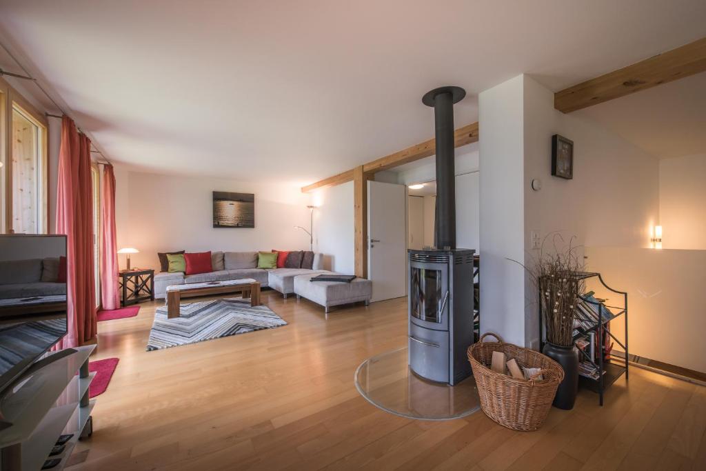 a living room with a stove in the middle of a room at Chalet Wyssbirg in Wengen