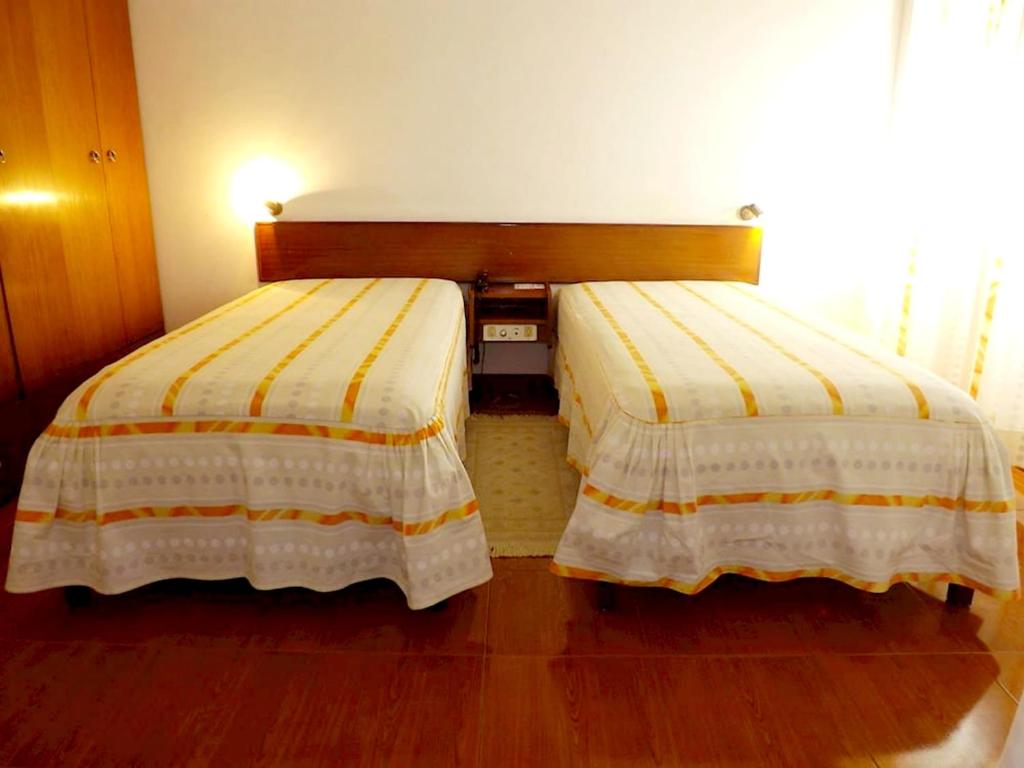 Postel nebo postele na pokoji v ubytování Aparthotel Avenida