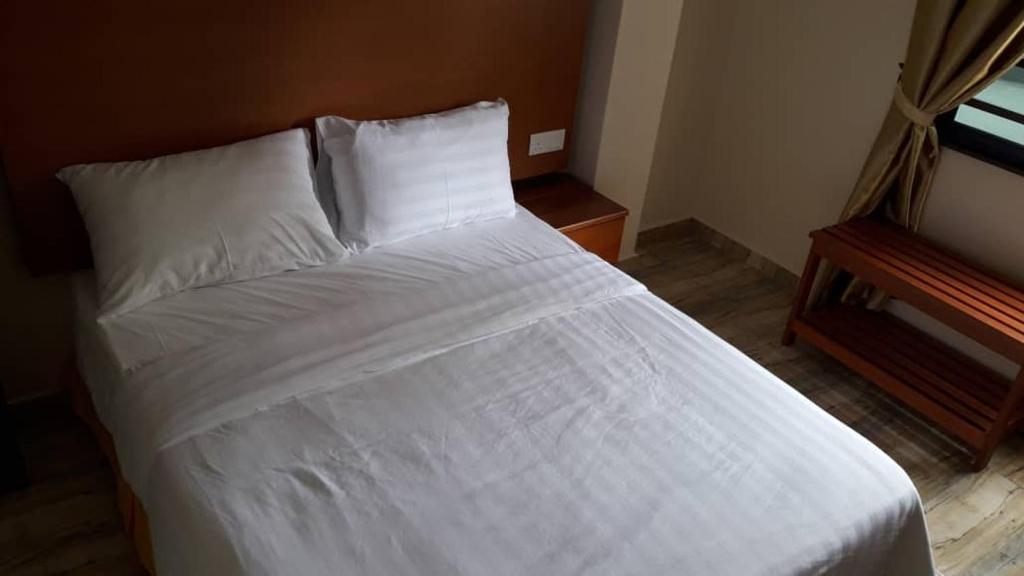 Postel nebo postele na pokoji v ubytování TULIP HOTEL & APARTMENT