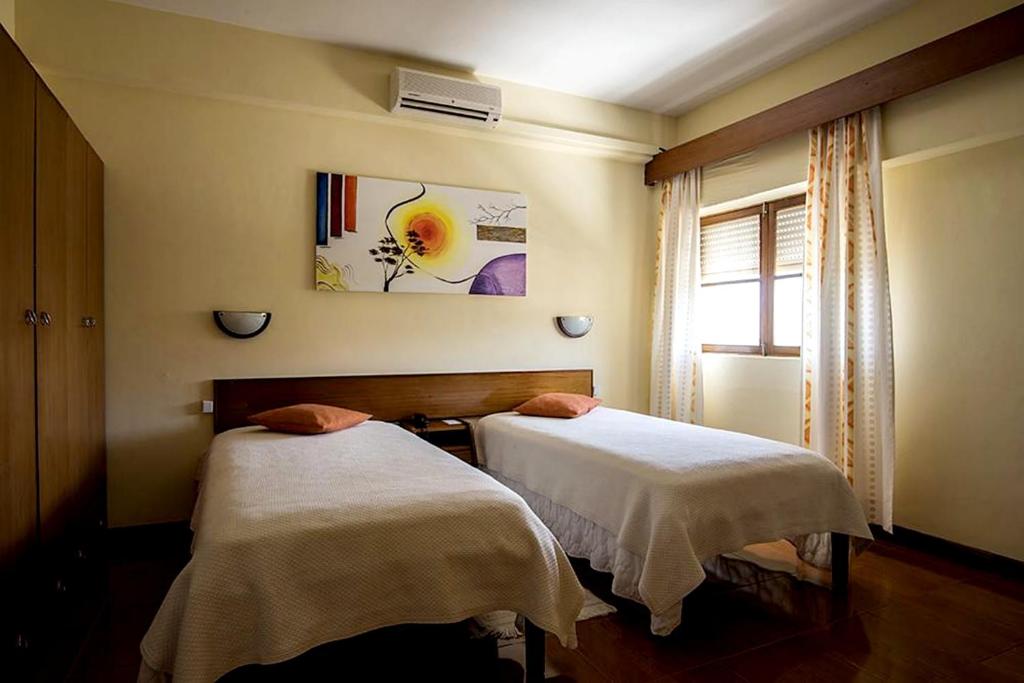 Postel nebo postele na pokoji v ubytování Aparthotel Avenida
