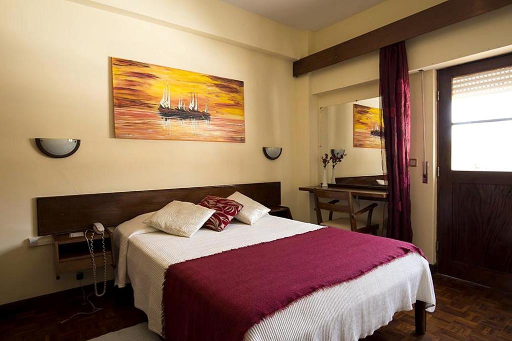 Postel nebo postele na pokoji v ubytování Aparthotel Avenida