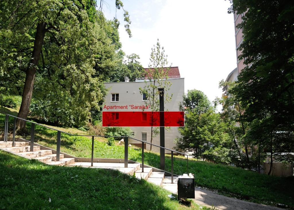 a building with a red sign in front of it at Apartment Sarajka Center in Sarajevo