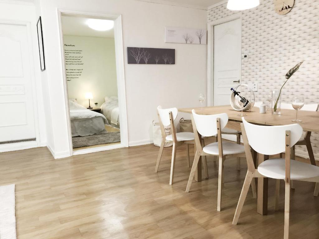 a dining room with a table and chairs and a bedroom at Hongdae Zoe Three Room House in Seoul