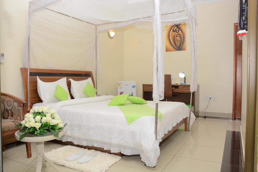 a bedroom with a bed with a canopy at Five to Five Hotel in Kigali
