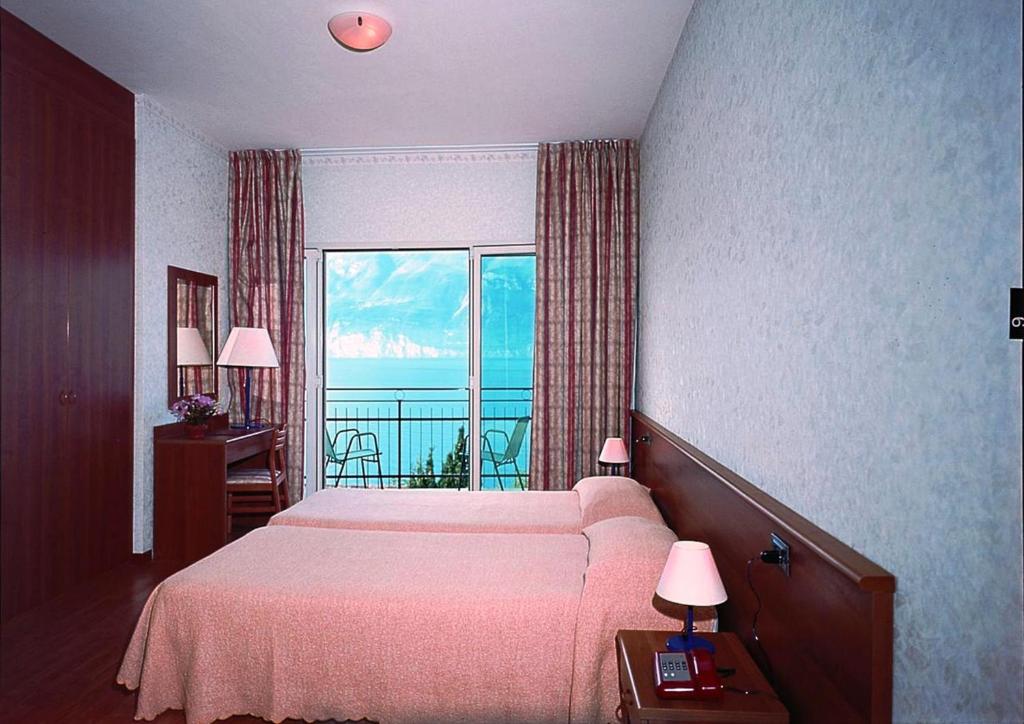 Postel nebo postele na pokoji v ubytování Hotel Nike