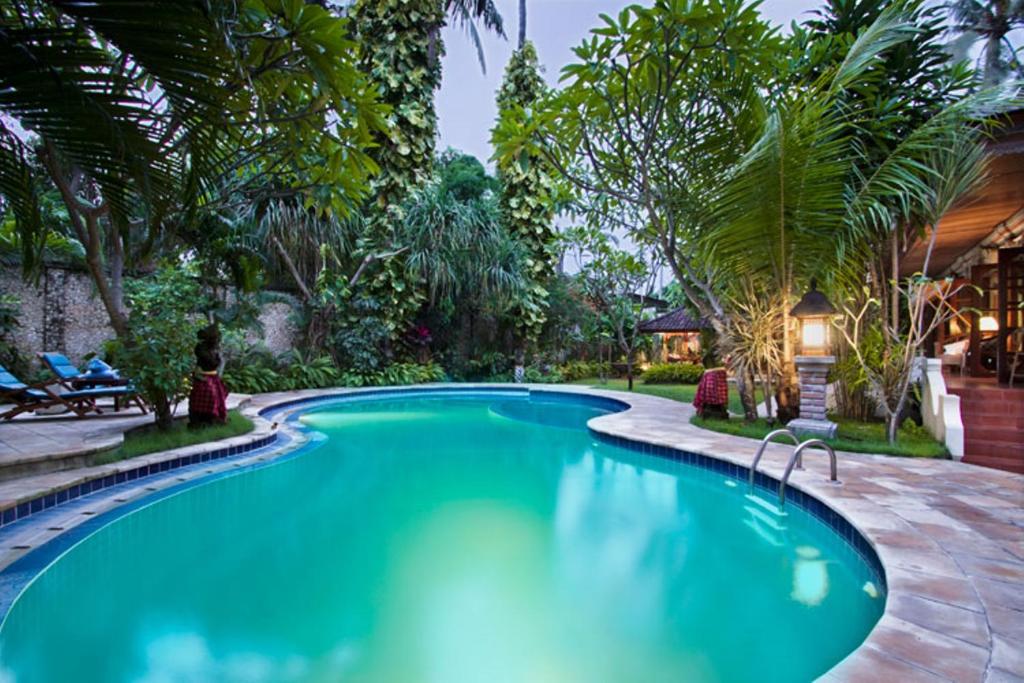 a swimming pool in the backyard of a house at Baliana Villa Legian in Legian