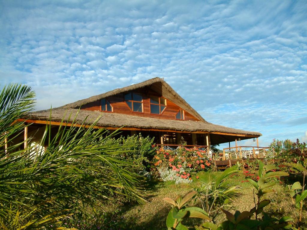 ein Haus mit einem Strohdach und einigen Pflanzen in der Unterkunft Nature Lodge in Diego Suarez