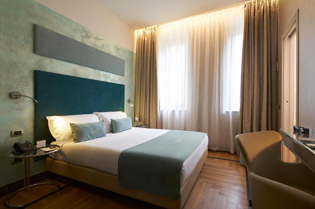 Postel nebo postele na pokoji v ubytování Bianca Maria Palace Hotel