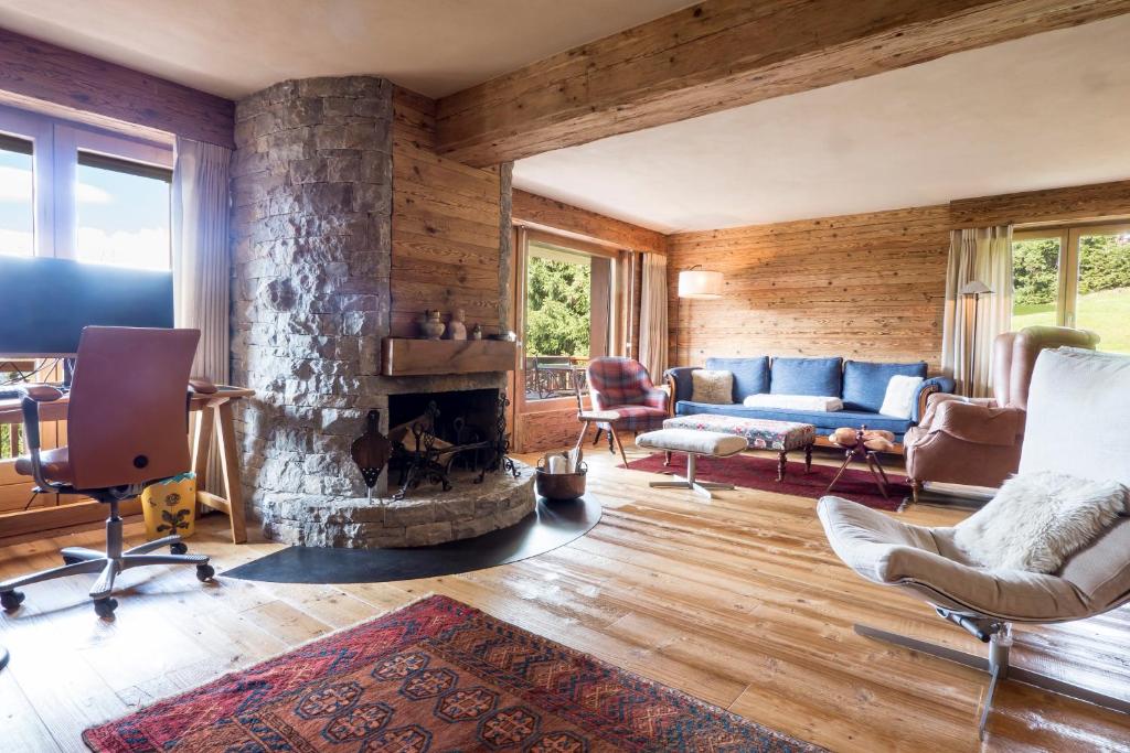 ein Wohnzimmer mit einem Sofa und einem Kamin in der Unterkunft Etoile du Sud in Verbier