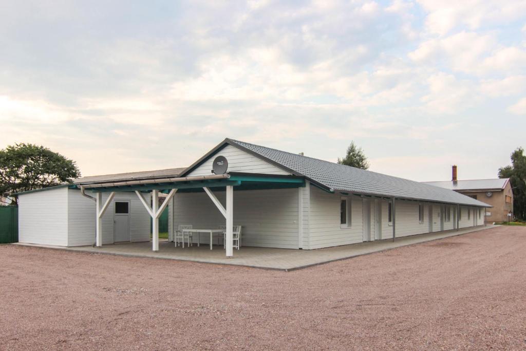 a large white building with a porch at Stax Motel in Gamstädt