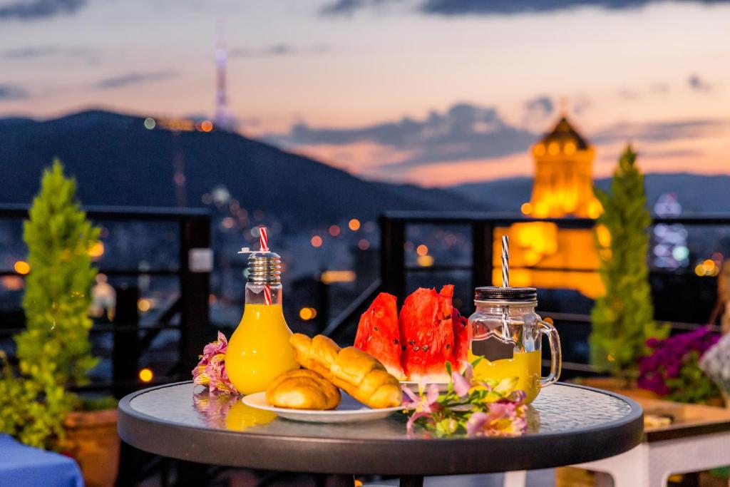 a plate of food on a table on a balcony at Ma Xata in Tbilisi City