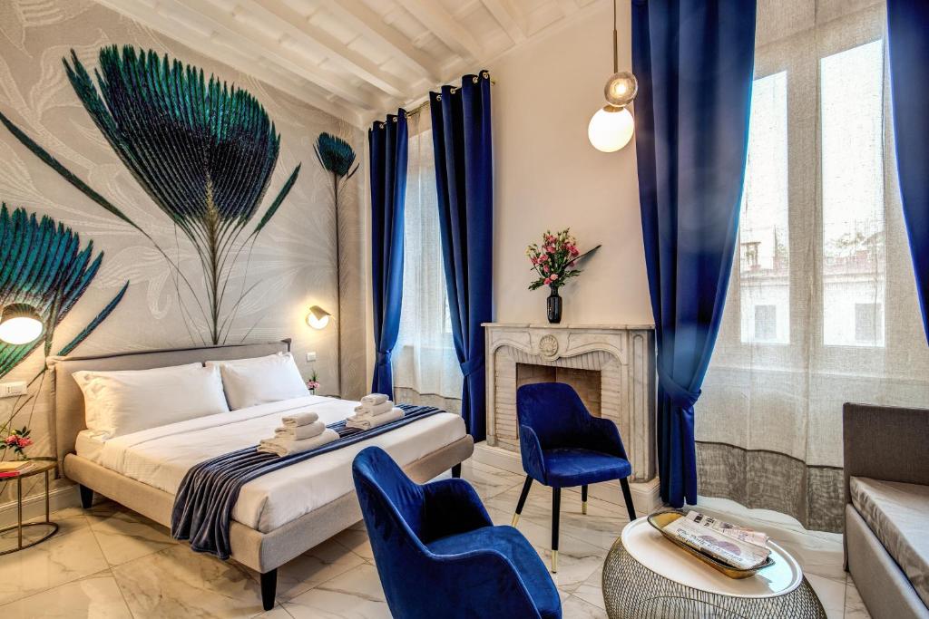 a bedroom with a bed and chairs and a fireplace at Little Queen Pantheon in Rome